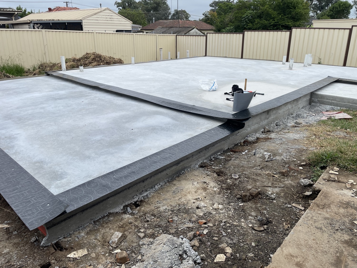 Concrete slab with perimeter termite barrier