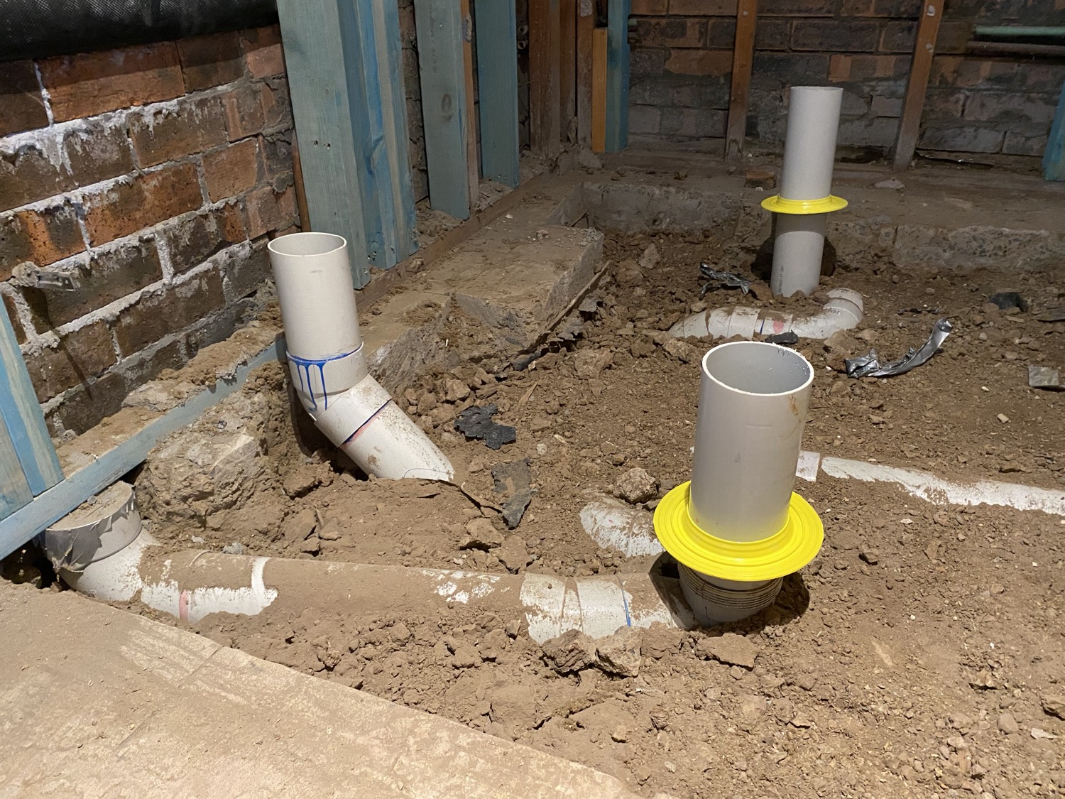 Subfloor termite barrier and pipe collars